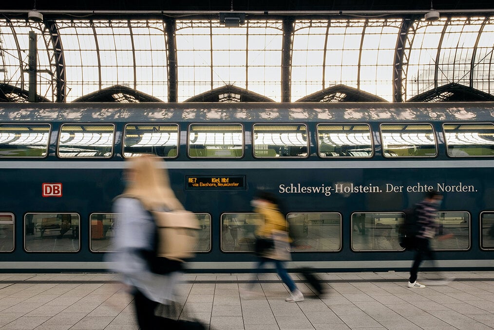 A train station in Germany with people around